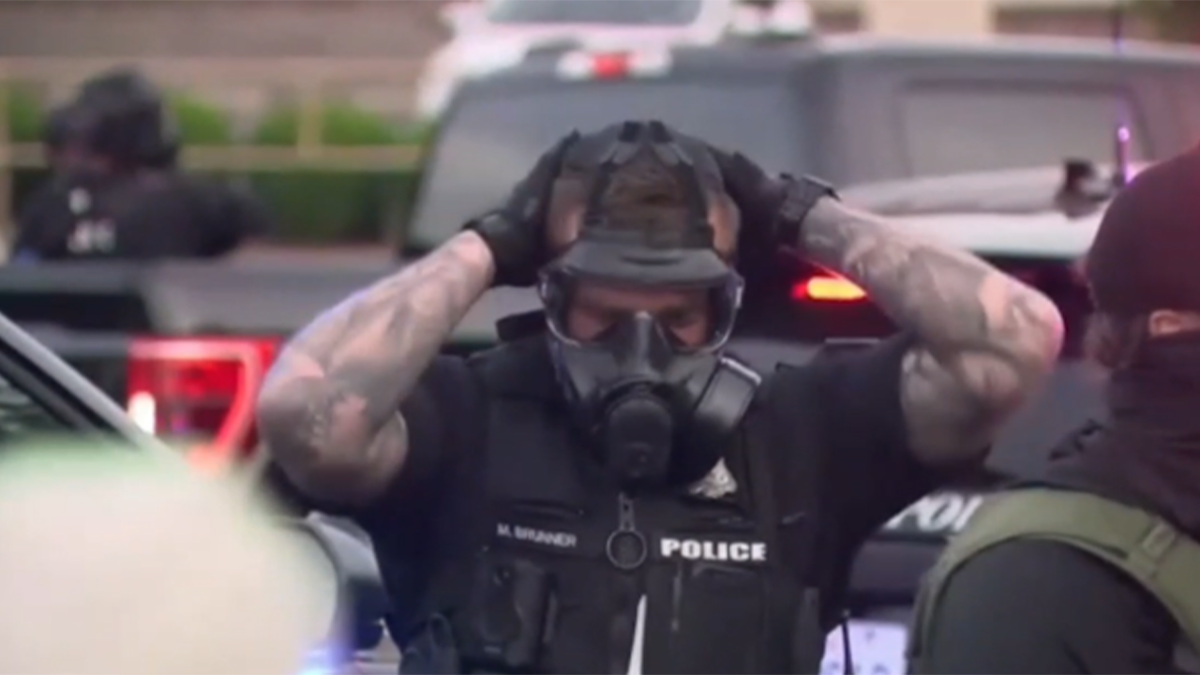 Spokan police officer wears a gas mask