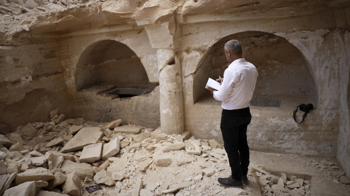 Man observing rubble in Syria