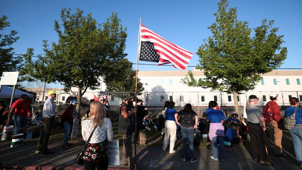 A person holds an upside down US flag during the "Tacoma May Day -