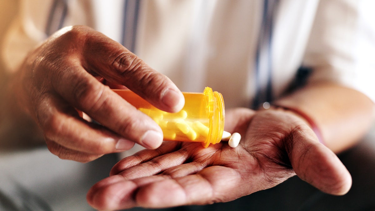 Hands, pills and bottles are large for a person with drugs, routine and home health schedule. Elderly Patient, Container and Pharmaceutical Product for Addresses, Healing and Retirement Benefits