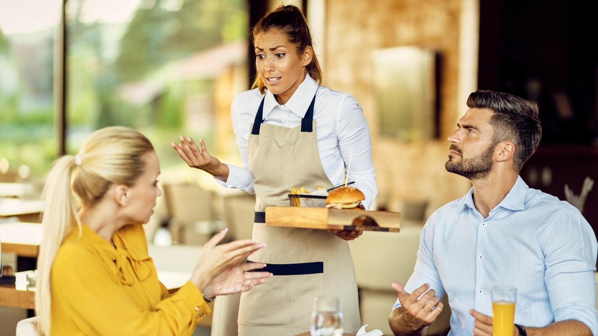 Waitress arguing with customers