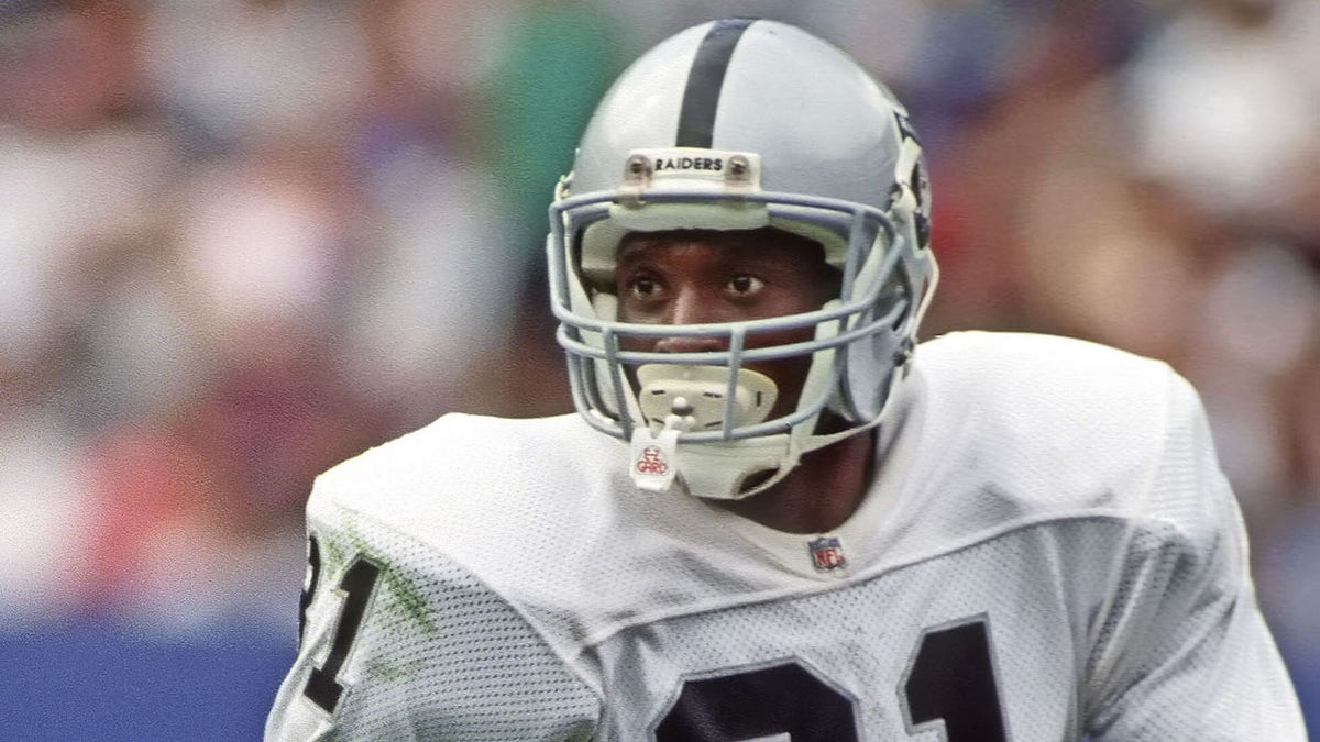 Tim Brown looks down field