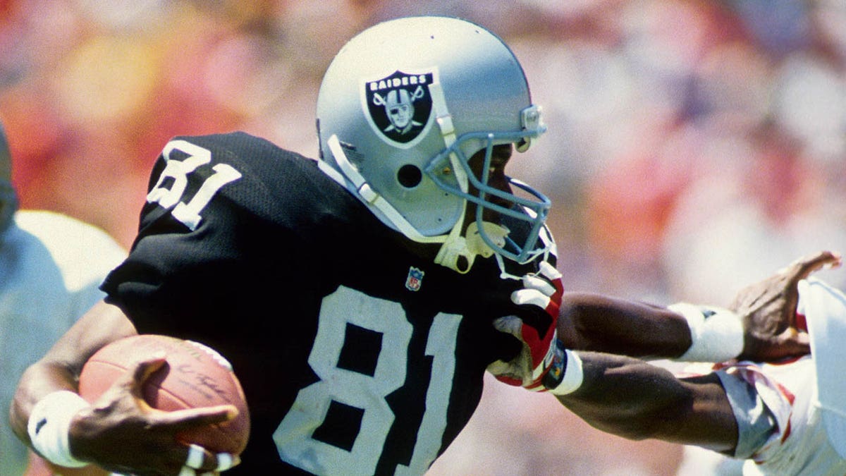 Tim Brown stiff arms defender