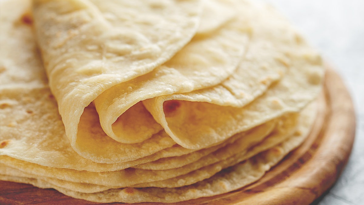 Close-up of folded tortillas on table