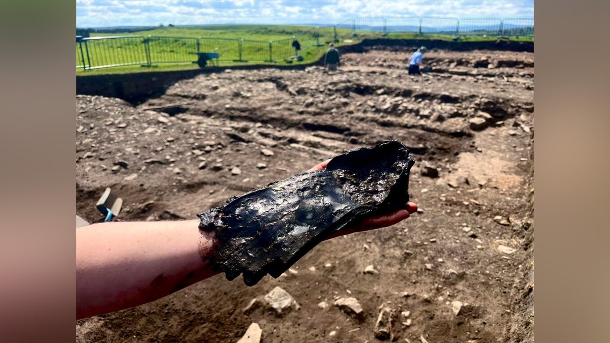 Volunteer holding shoe