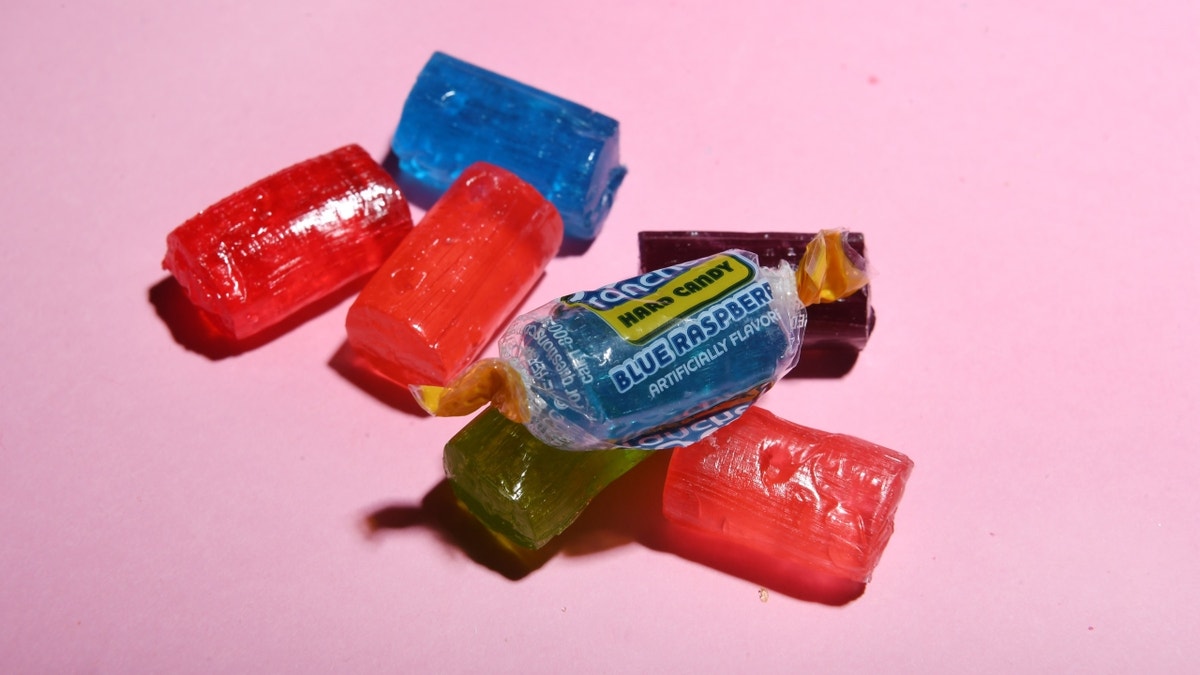 Jolly Ranchers candy against pink background