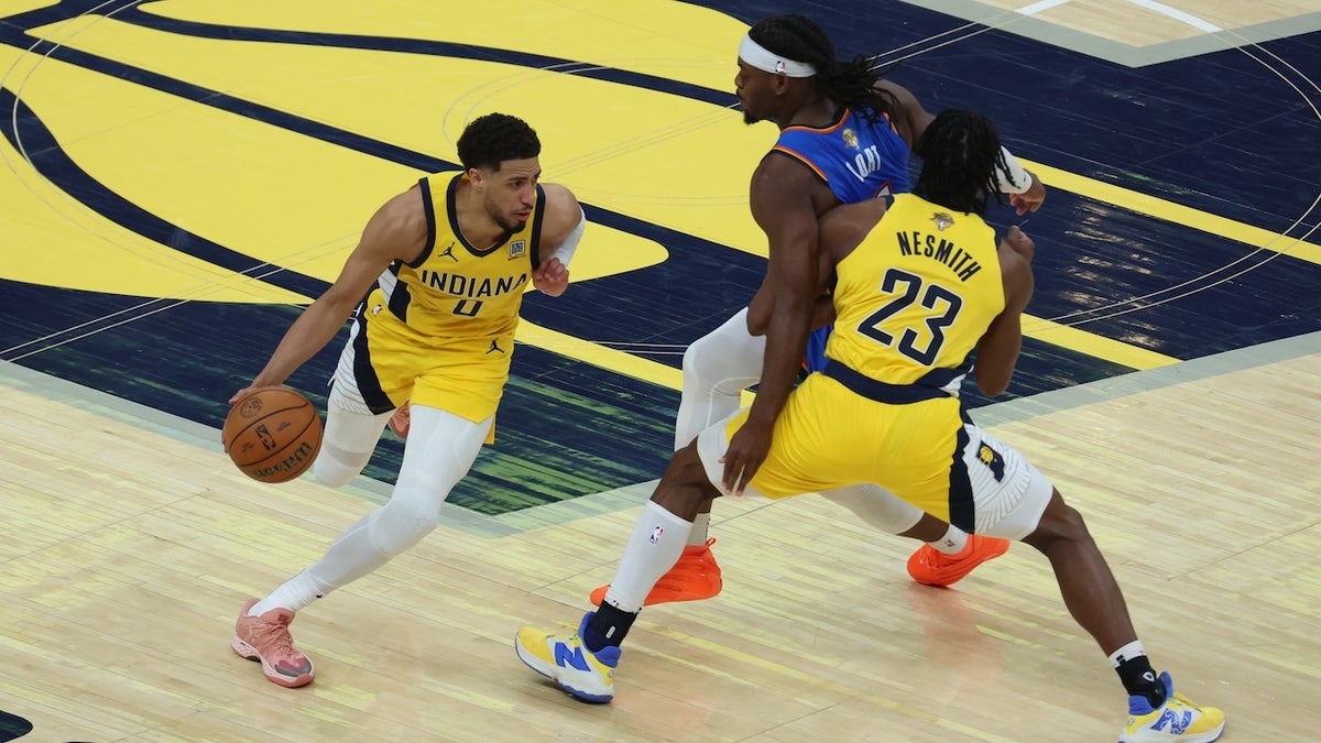Jun 13, 2025; Indianapolis, Indiana, USA; Indiana Pacers guard Tyrese Haliburton (0) drives to the hoop as Indiana Pacers forward Aaron Nesmith (23) blocks Oklahoma City Thunder guard Luguentz Dort (5) during the second quarter of game four of the 2025 NBA Finals at Gainbridge Fieldhouse. 