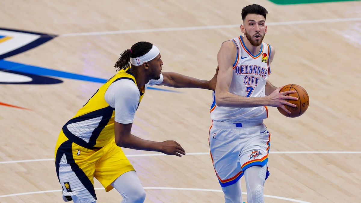 Oklahoma City Thunder forward Chet Holmgren (7) drives to the basket past Indiana Pacers center Myles Turner (33) in the first quarter during game five of the 2025 NBA Finals at Paycom Center.