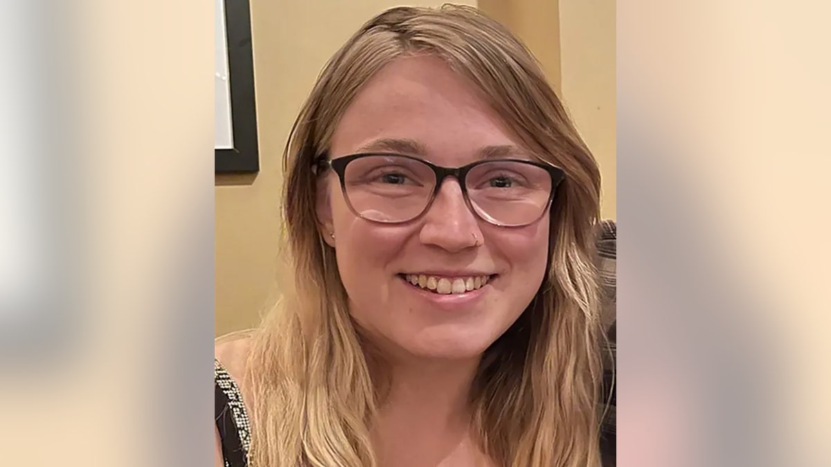 A close-up of Emily Ferlazzo smiling wearing glasses.