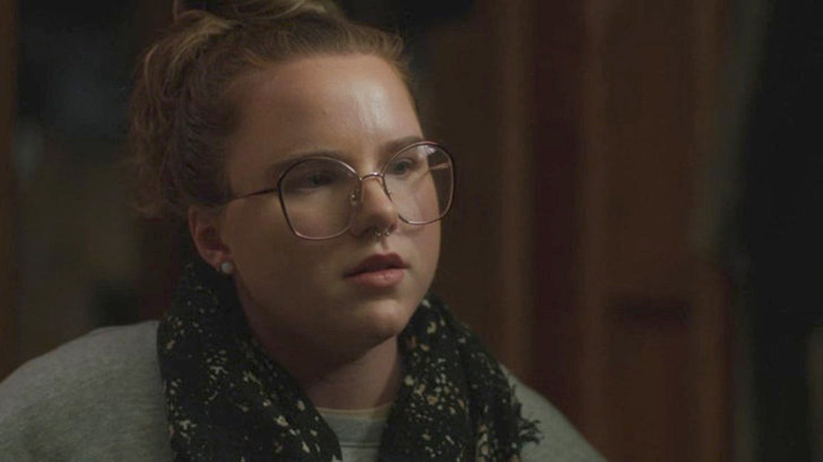 Victoria Heuermann wearing glasses and speaking in mid-sentence.
