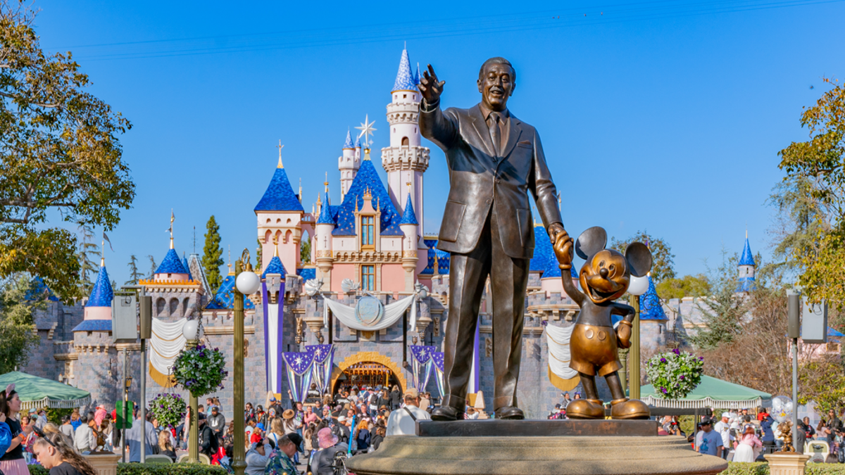 A statue stands of Walt Disney