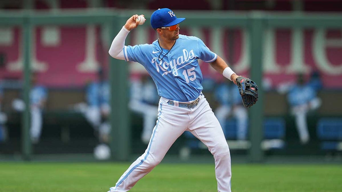Whit Merrifield throws to first base