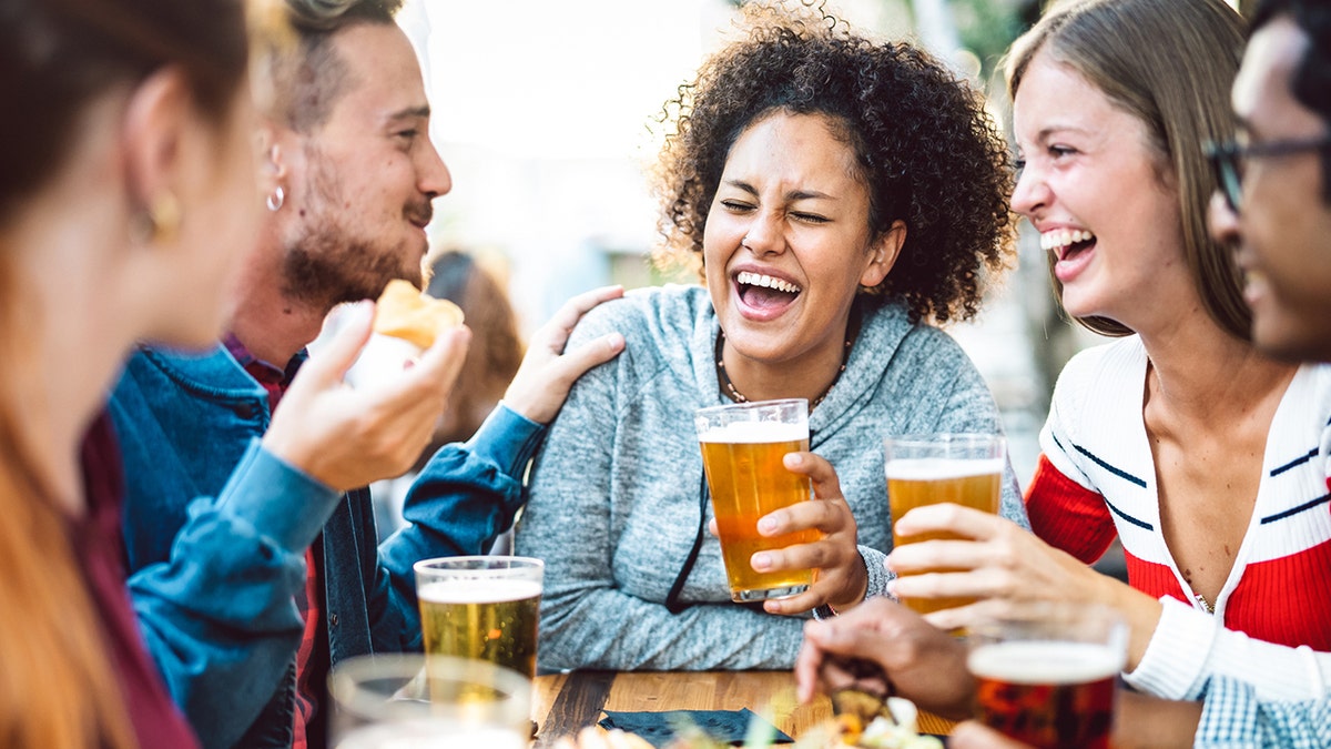 woman drinking with friends happy hour