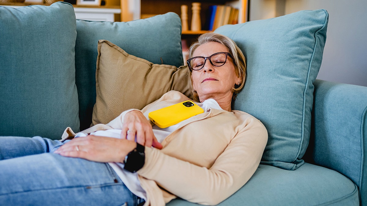 Study links frequent daytime napping to higher mortality in older adults 3 Tired woman taking a nap on the sofa in the living room