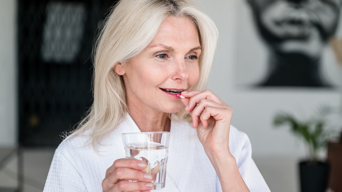 Woman taking pill