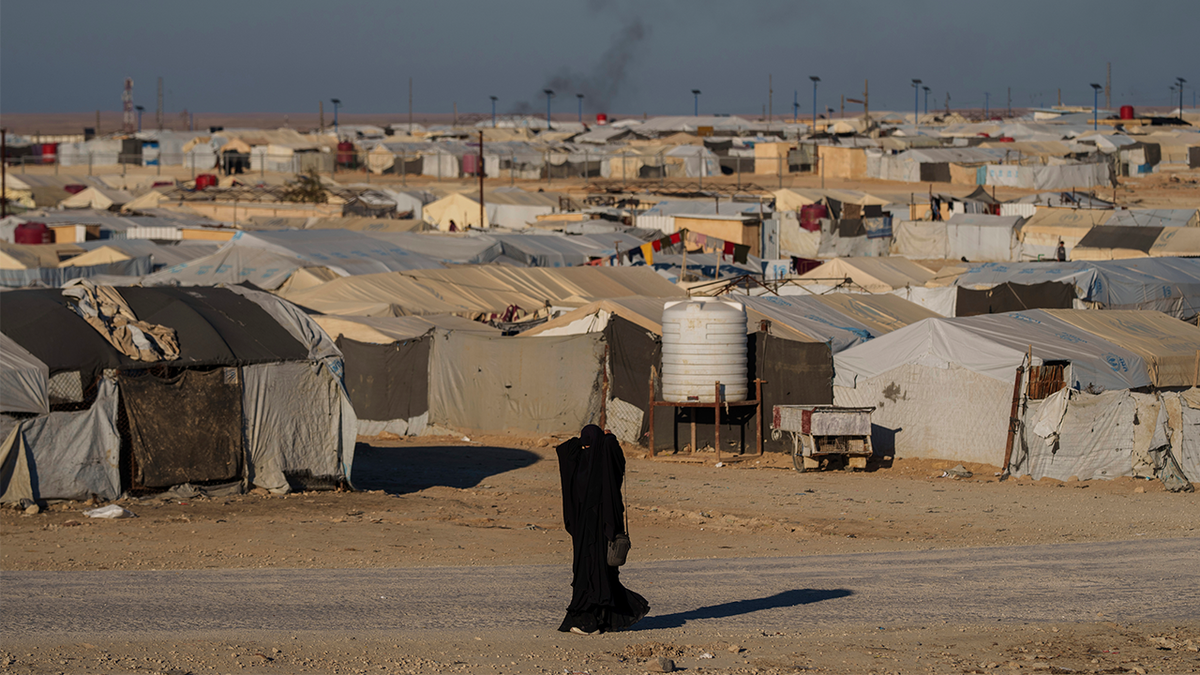 A woman walks in the al-Hol camp in northeastern Syria's Hasakeh province