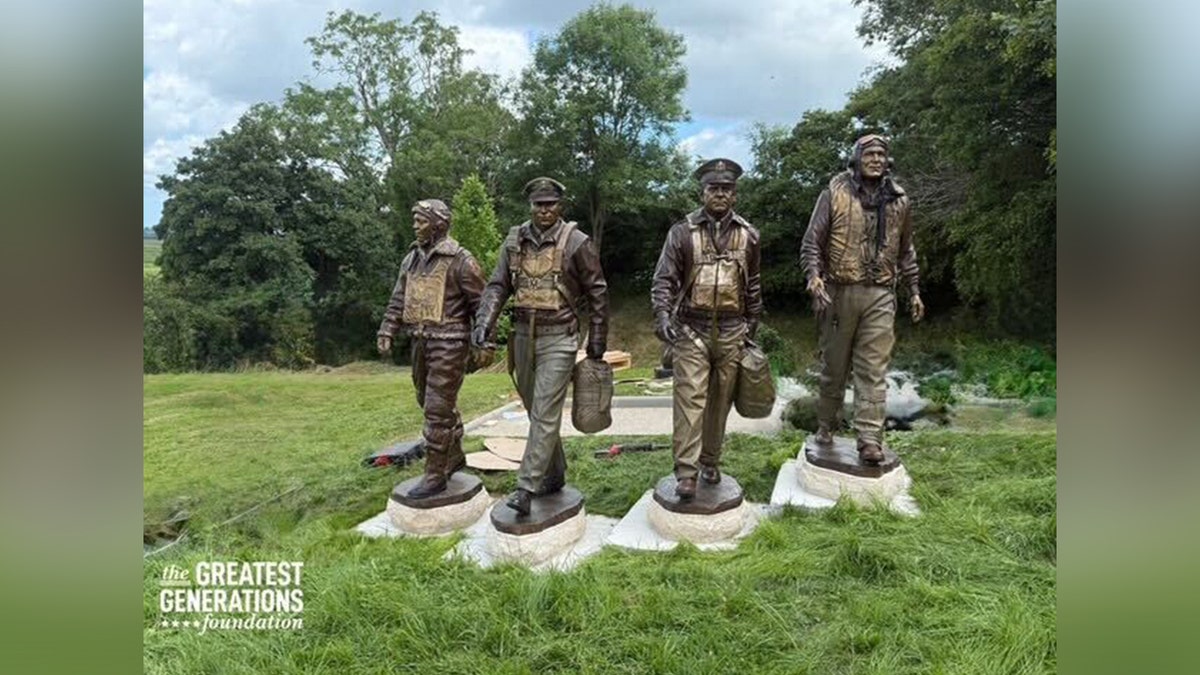 Statues of World War II veterans connected grass