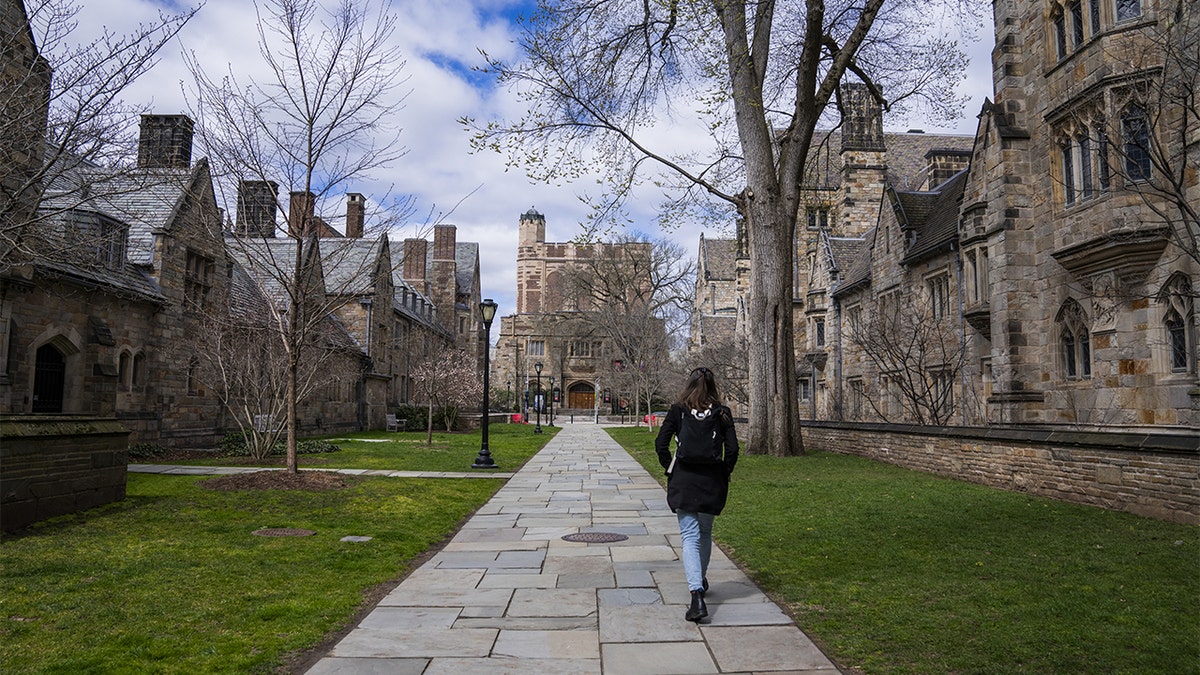 A Yale student walks through campus.