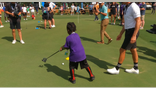 Dallas ISD student practices putting with HyFlyer player Cameron Tringale.