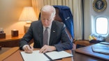Joe Biden signing document