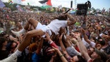 Bobby of Bob Vylan crowdsurfs at Glastonbury
