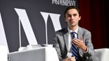 Hogg on stage in a suit