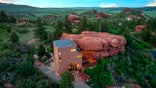 Check out this real-life Flintstones home built around a 200 million-year-old red rock. The two-bedroom house in Larkspur, Colorado, US, has a very unique style - perfect for a Flintstone fan. The property - nicknamed the rock house - is integrated with nature, nestled around a 45ft high section of one of Colorado's beloved 200-million-year-old red rocks. On the market for $1m, the property "transforms nature's artistry into a one-of-a-kind architectural statement". The property boasts walking trails, a picnic area, Milky Way views from the private hot tub, and all the peace and serenity a homeowner could wish for.