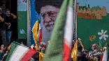Supreme Leader Ayatollah Ali Khamenei image on the wall during a pro-Iran demonstration