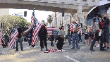 Several protesters wave American flags in a city street