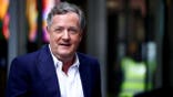 Piers Morgan looks on