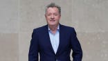 Piers Morgan looks on