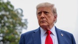 U.S. President Donald Trump stops and talks to the media
