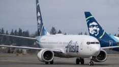 Passenger in custody after 'direct threat' to airplane shuts down Seattle Airport runways