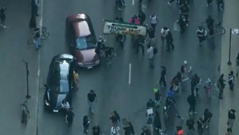 Car plows through protesters as police vehicles vandalized in growing unrest - Fox News