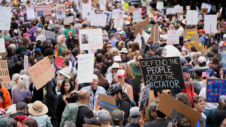 Demonstrators at the ⁣'No Kings' protest in Portland, Oregon.