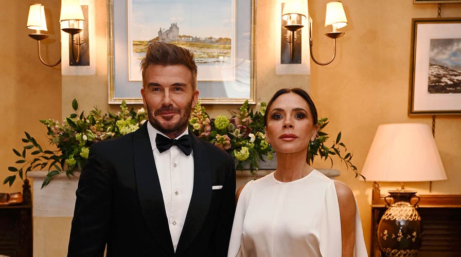 David Beckham waves to fans while walking the green carpet at the Earthshot Prize Awards