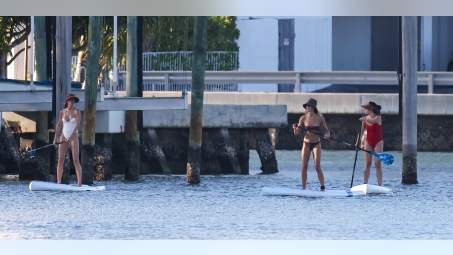 Gisele Bundchen paddle-boarding with friends