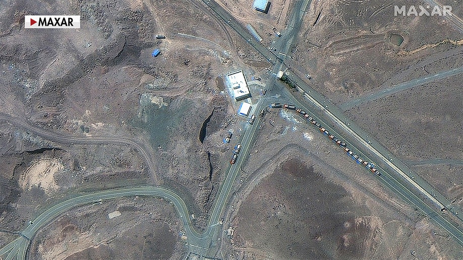 cargo trucks positioned near underground entrance of Fordow