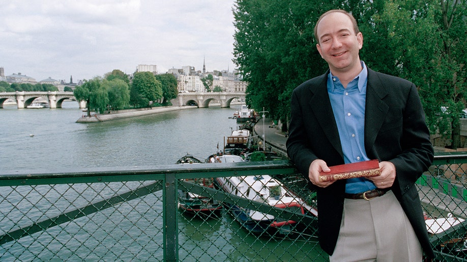 Jeff Bezos standing on a bridge in France.