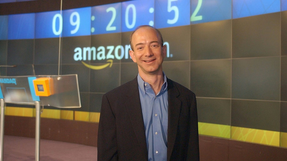 Jeff Bezos standing in front of a big screen at the opening of The NASDAQ Stock Market.