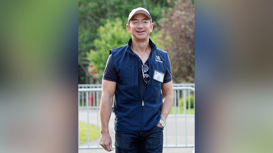 Jeff Bezos in jeans and a blue vest in Idaho.