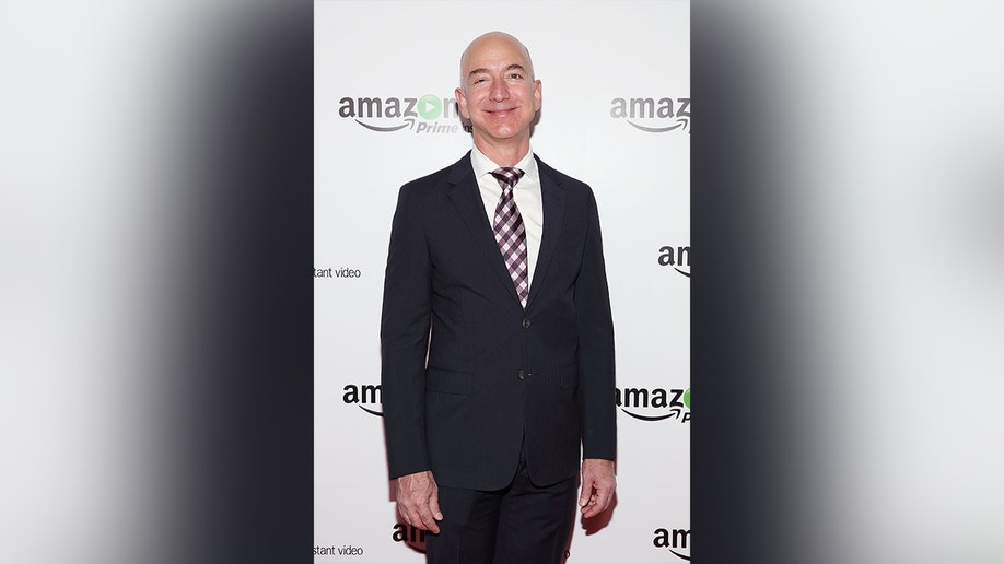 Jeff Bezos in a suit and tie on the red carpet.