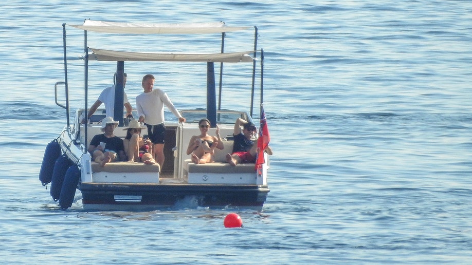 Jeff Bezos, Lauren Sanchez and another couple relaxing on daybeds.
