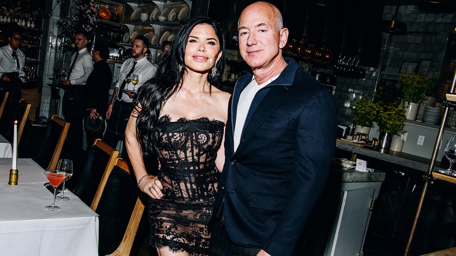 Jeff Bezos and Lauren Sanchez at a cocktail party.