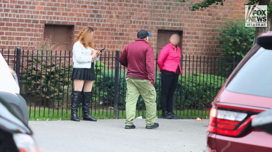 A man walks past two alleged prostitutes in Queens