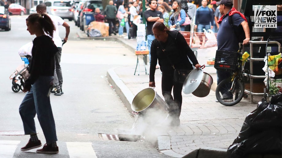 A woman dumps waste water down a drain on Roosevelt Avenue in Queens.