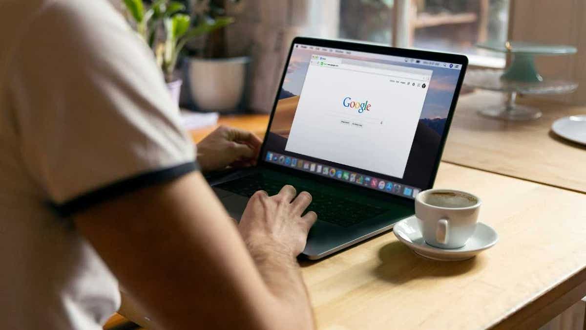 A person browses Google on a laptop.