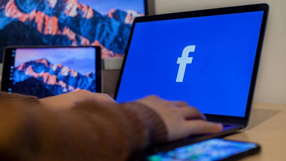 A person using Facebook on their laptop.