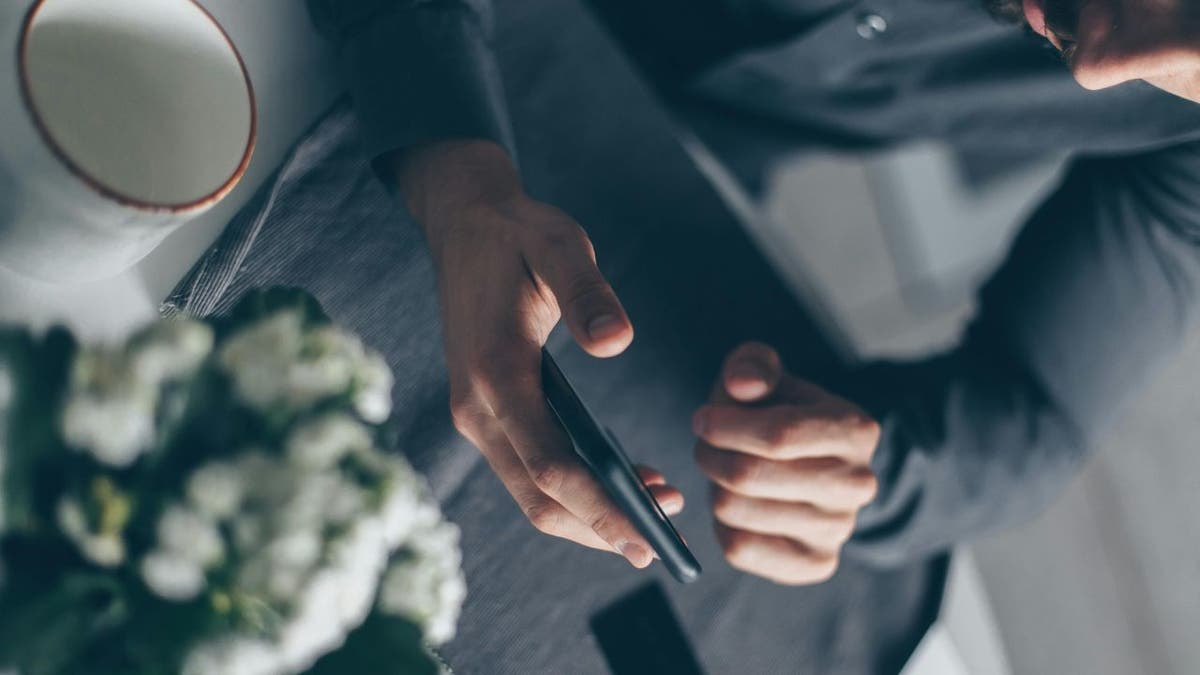 man scrolling phone