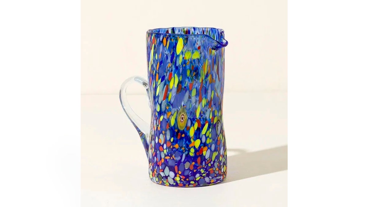 This artisan glass pitcher doubles as servewear and a decorative piece for your outdoor table.